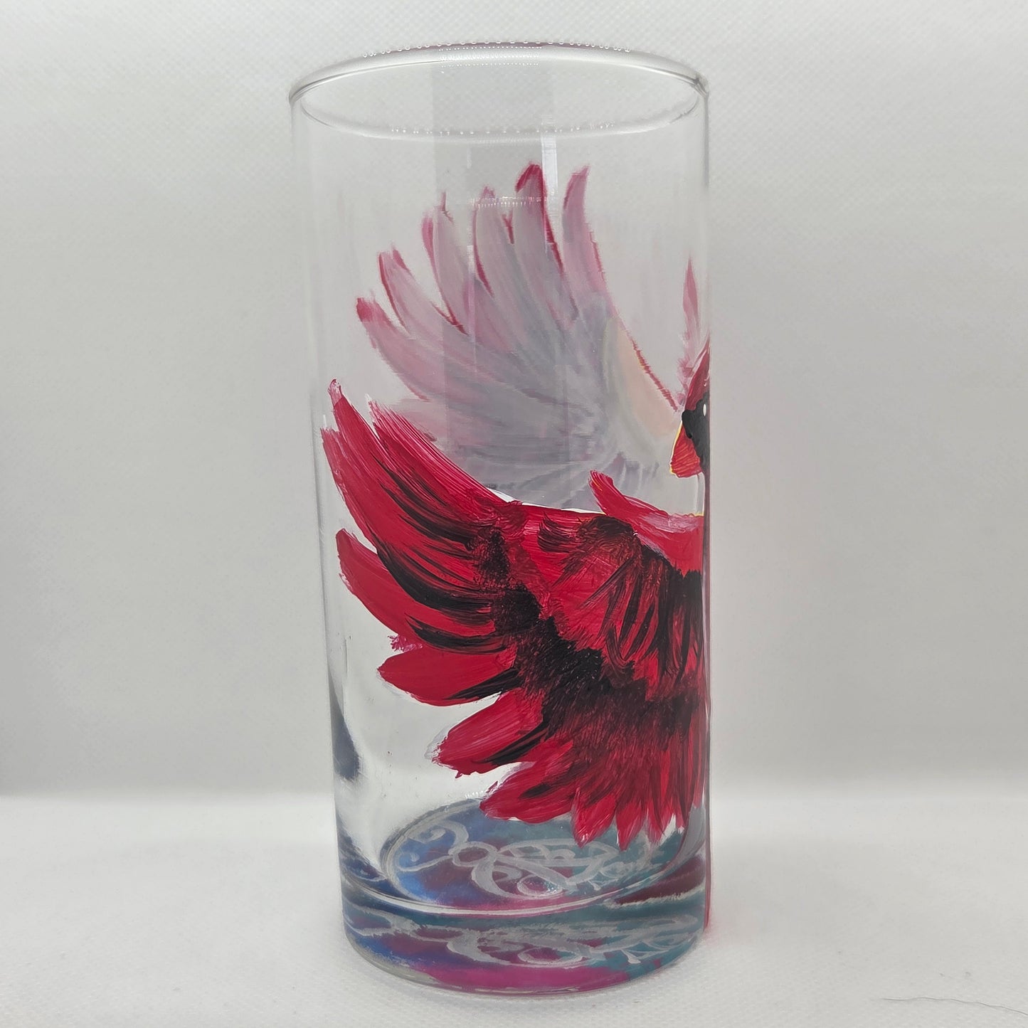 Hand-painted 16 oz tumbler featuring a bold red cardinal facing forward with wings spread wide