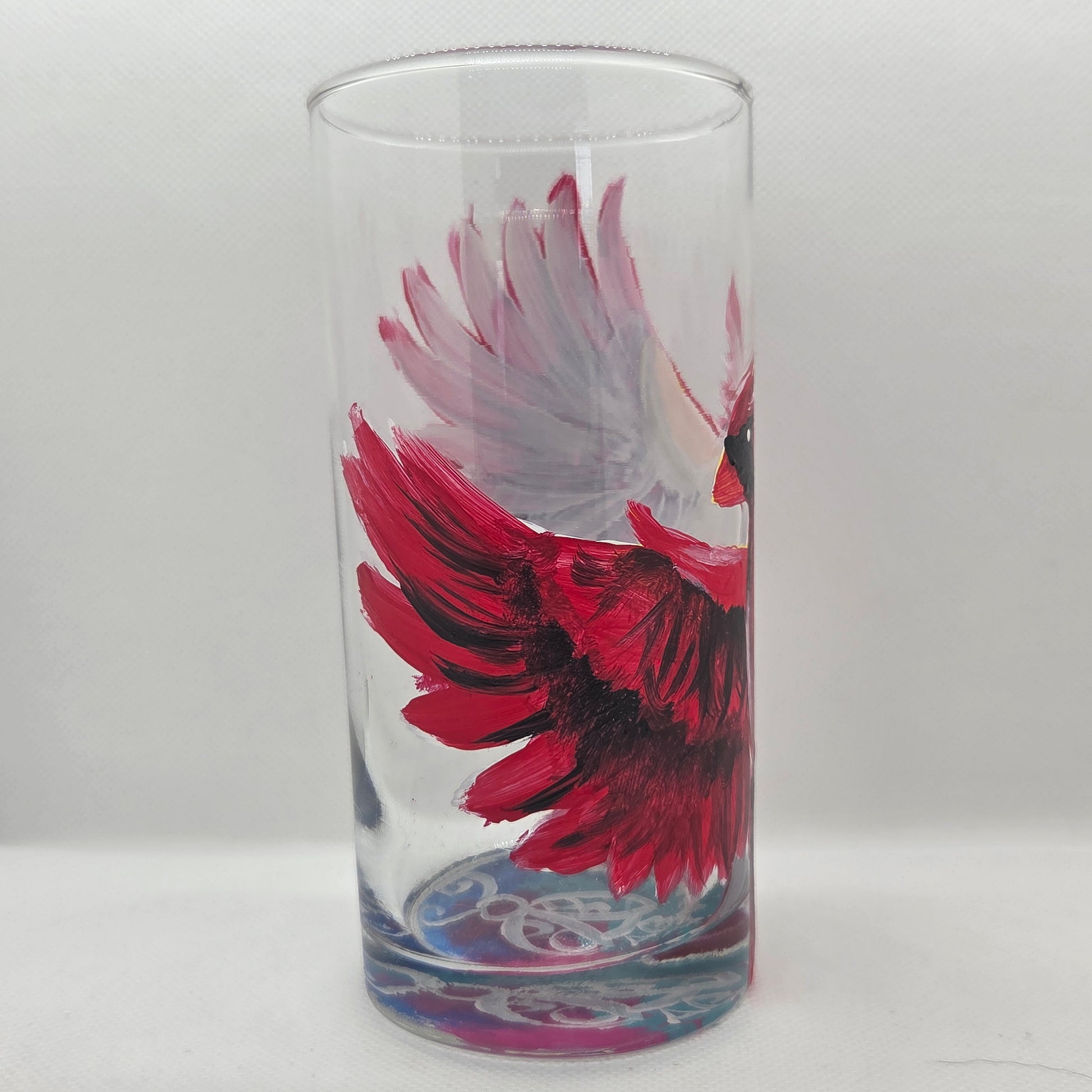 Hand-painted 16 oz tumbler featuring a bold red cardinal facing forward with wings spread wide