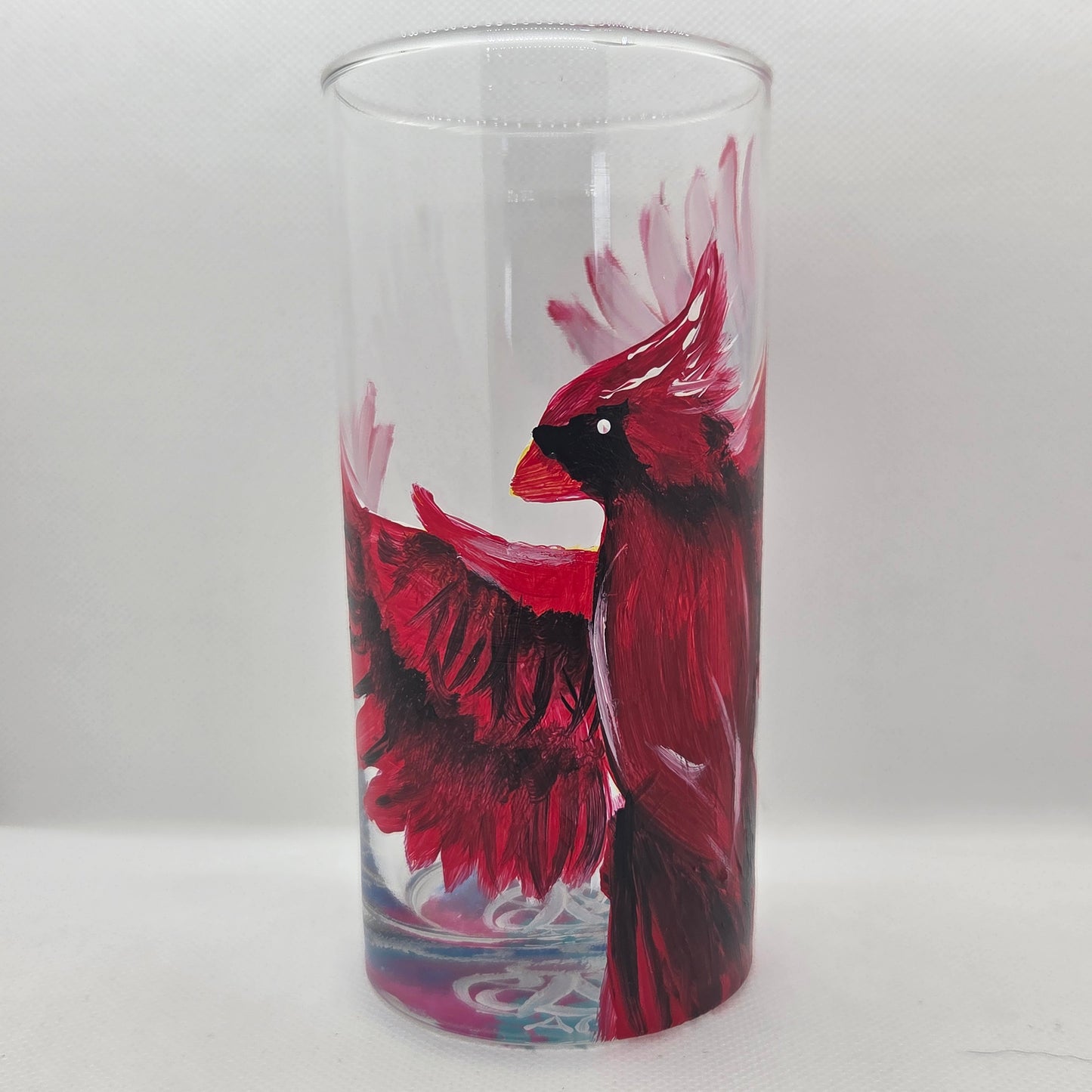 Hand-painted 16 oz tumbler featuring a bold red cardinal facing forward with wings spread wide