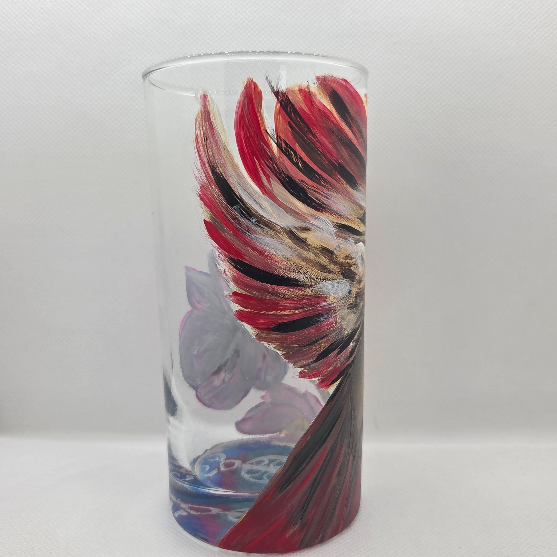 Hand-painted 16 oz tall tumbler with a female cardinal spreading her wings among large pink blossoms