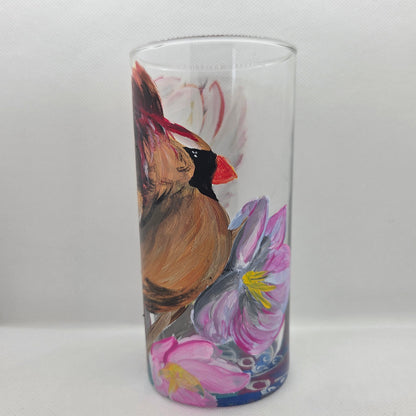Hand-painted 16 oz tall tumbler with a female cardinal spreading her wings among large pink blossoms