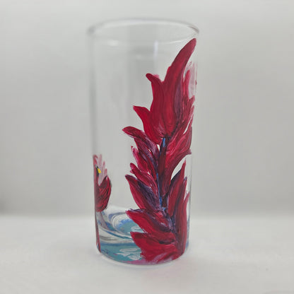 Hand-painted 16 oz tall tumbler with two flying cardinals surrounding a flowing feather