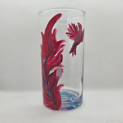 Hand-painted 16 oz tall tumbler with two flying cardinals surrounding a flowing feather