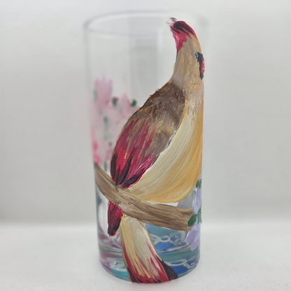Hand-painted 16 oz tall tumbler with a female cardinal perched on a flowering branch surrounded by red, white, blue, and pink blossoms