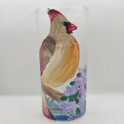 Hand-painted 16 oz tall tumbler with a female cardinal perched on a flowering branch surrounded by red, white, blue, and pink blossoms