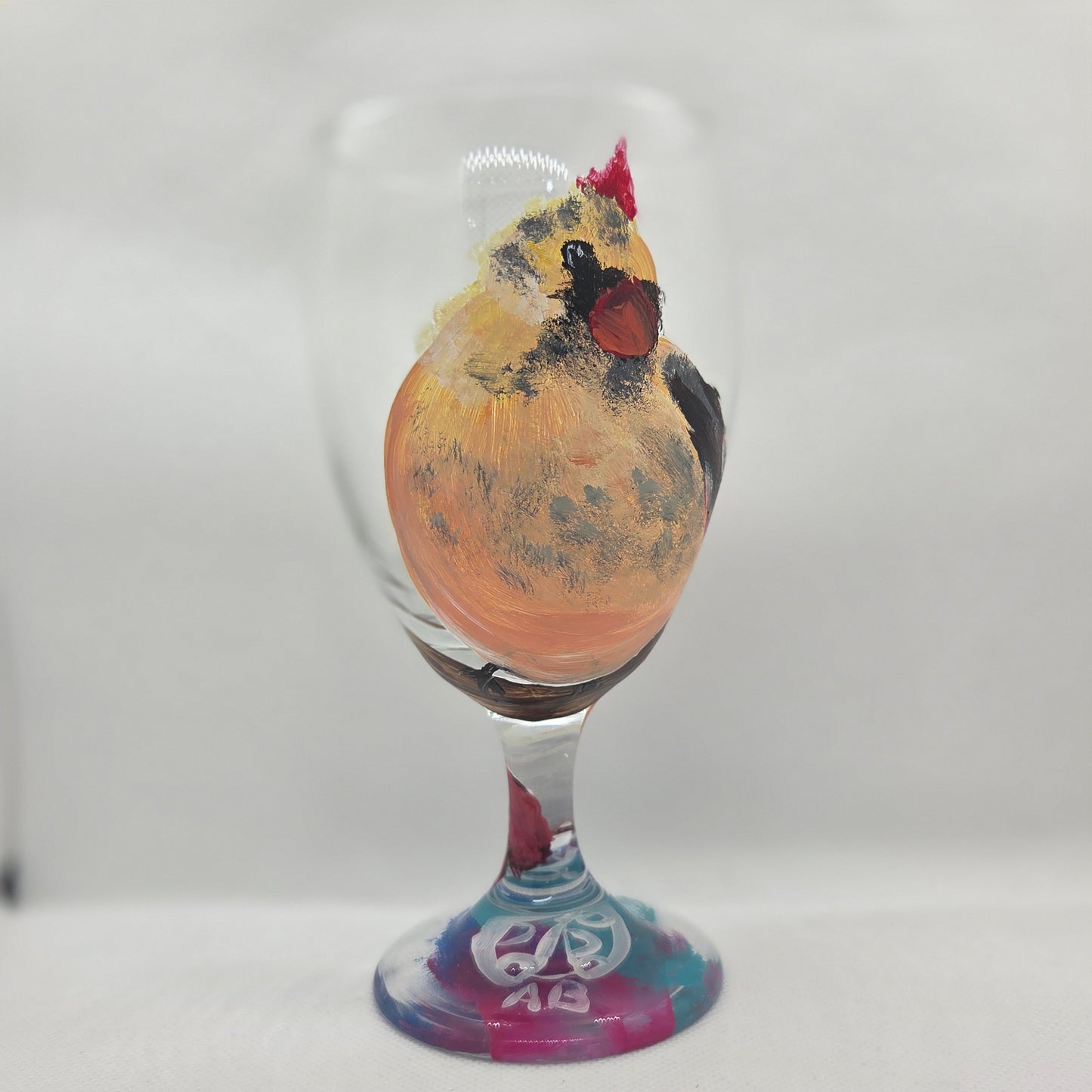 Hand-painted 16 oz goblet with a fluffy cream-colored female cardinal with pink accents and wings tucked behind her back