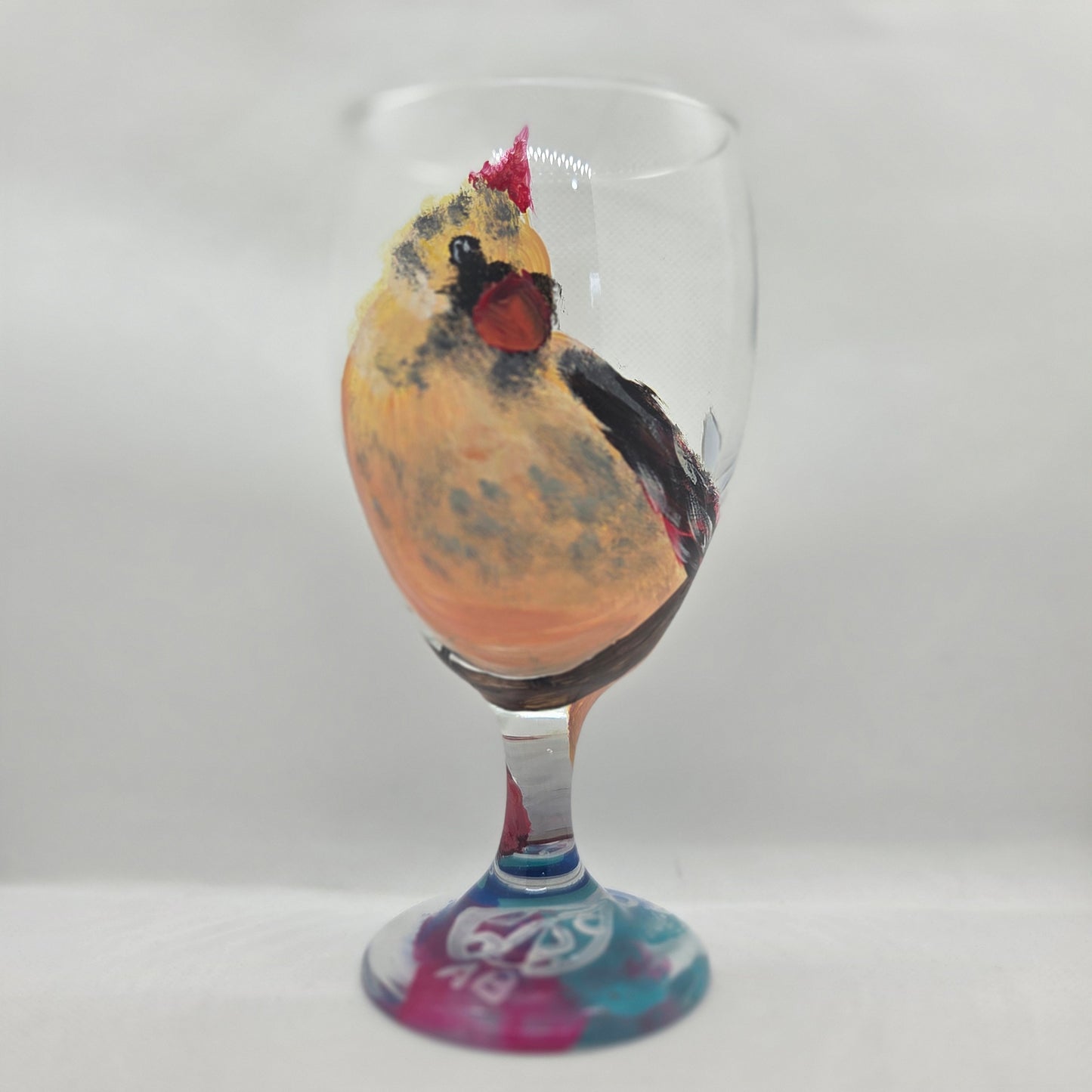 Hand-painted 16 oz goblet with a fluffy cream-colored female cardinal with pink accents and wings tucked behind her back