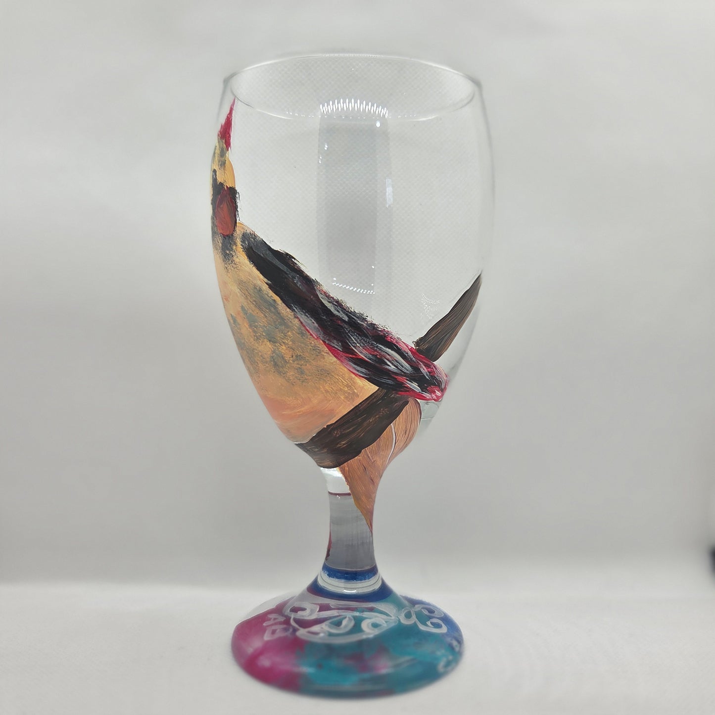 Hand-painted 16 oz goblet with a fluffy cream-colored female cardinal with pink accents and wings tucked behind her back