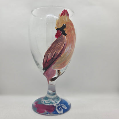 Hand-painted 16 oz goblet with a female cardinal looking over her shoulder, perched on a branch with peach-pink coloring