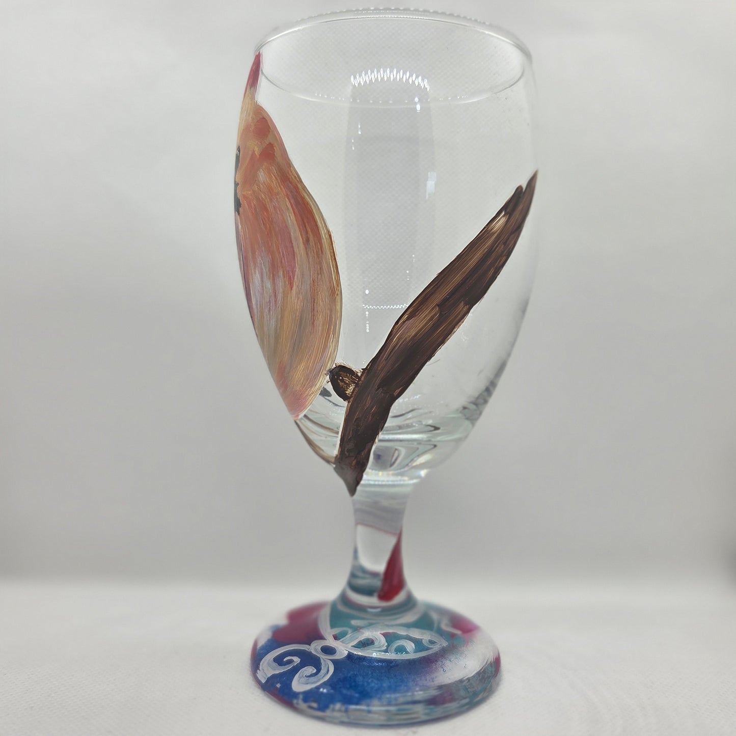 Hand-painted 16 oz goblet with a female cardinal looking over her shoulder, perched on a branch with peach-pink coloring