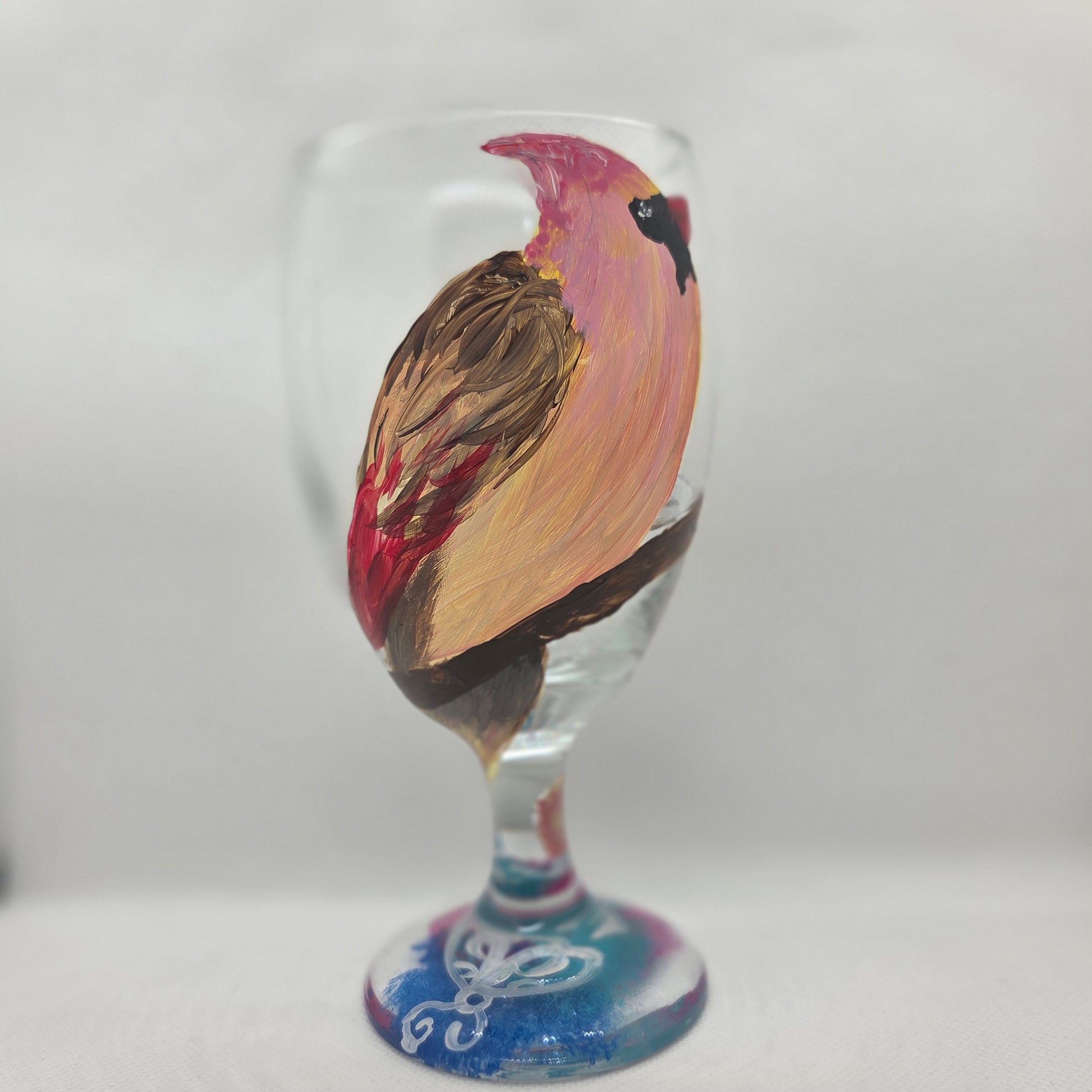 Hand-painted 16 oz glass with a pink-toned female cardinal perched on a branch and looking upward