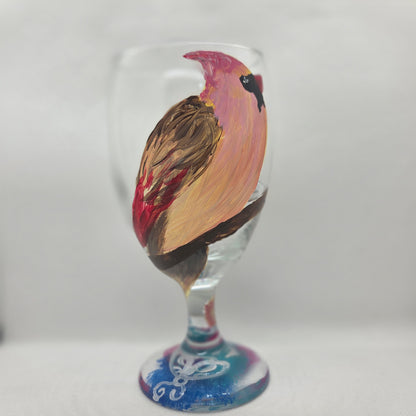 Hand-painted 16 oz glass with a pink-toned female cardinal perched on a branch and looking upward
