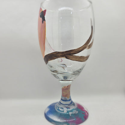 Hand-painted 16 oz glass with a pink-toned female cardinal perched on a branch and looking upward