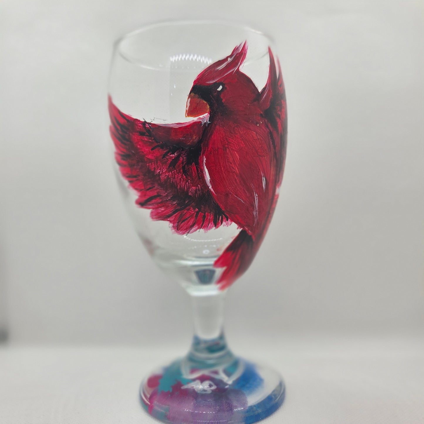 Hand-painted 16 oz goblet with a bold red cardinal facing forward and spreading his wings