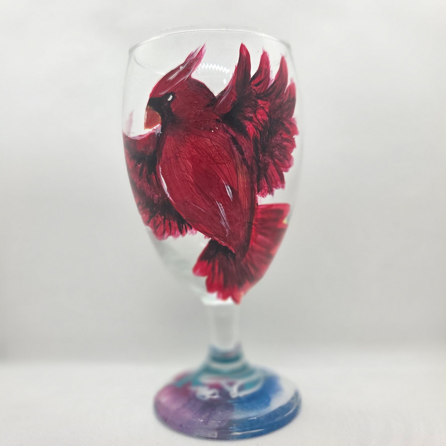 Hand-painted 16 oz goblet with a bold red cardinal facing forward and spreading his wings