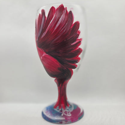 Hand-painted glass featuring a red male cardinal in flight looking down as he approaches his landing perch