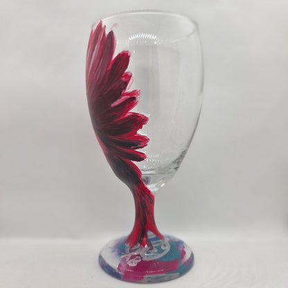 Hand-painted glass featuring a red male cardinal in flight looking down as he approaches his landing perch