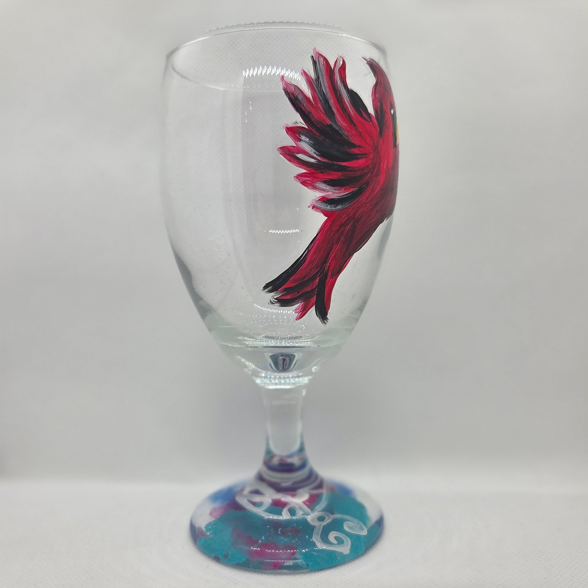 Hand-painted 16 oz goblet featuring a complete red cardinal in flight with bold black and white details