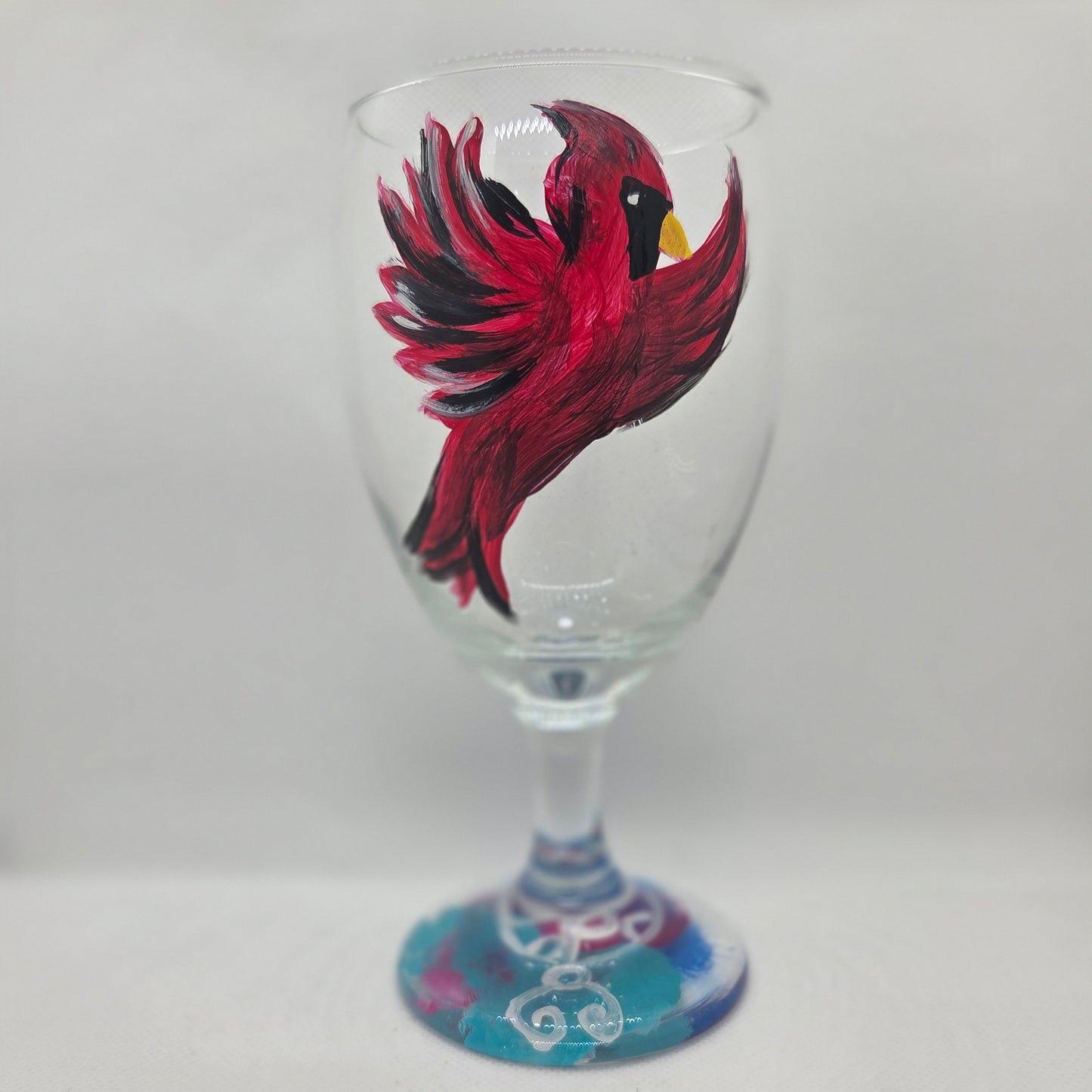 Hand-painted 16 oz goblet featuring a complete red cardinal in flight with bold black and white details