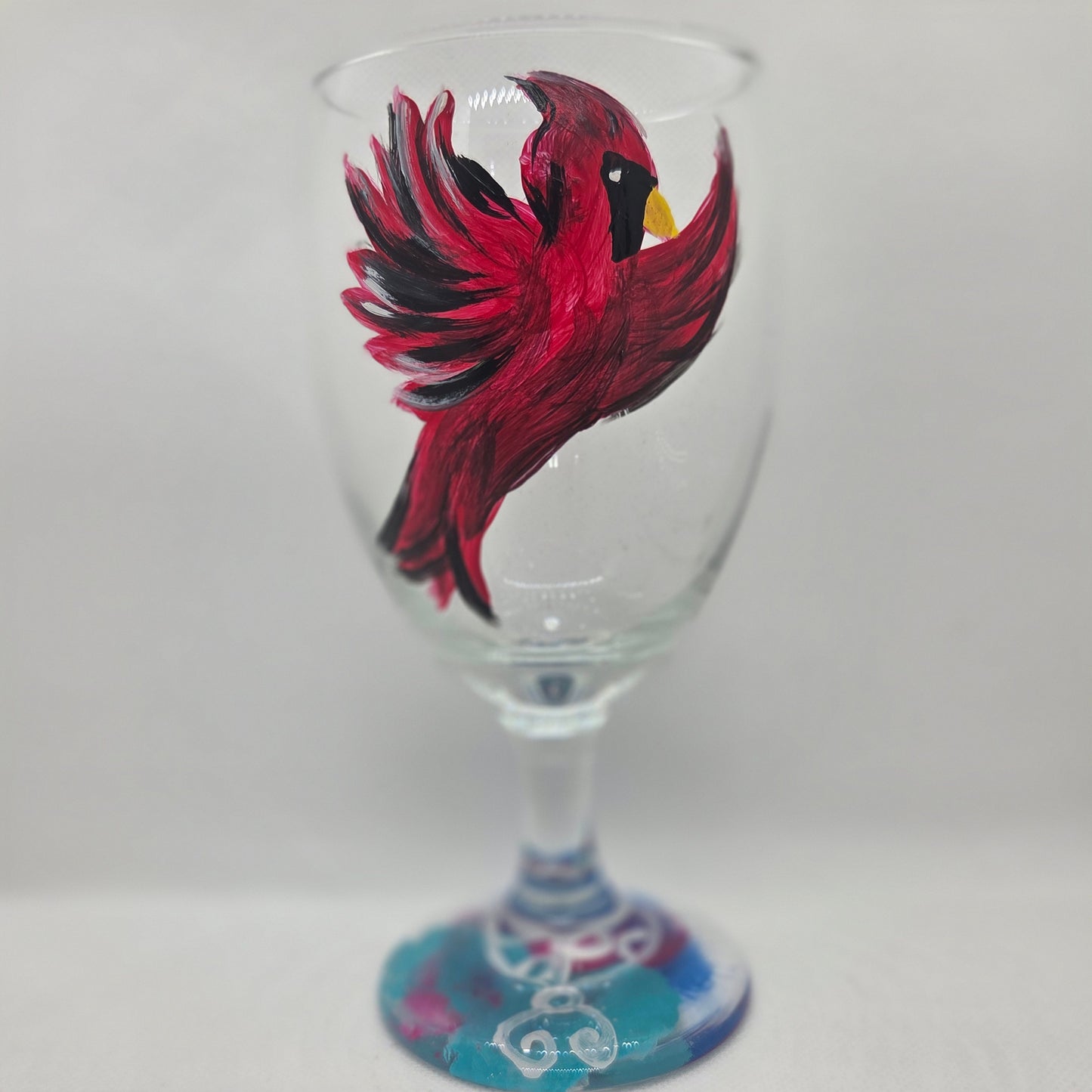 Hand-painted 16 oz goblet featuring a complete red cardinal in flight with bold black and white details