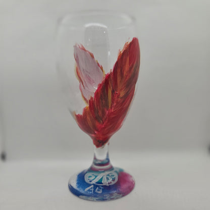 Hand-painted 16 oz goblet with two upright cardinal feathers in red, orange, and golden yellow