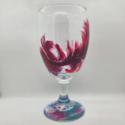 Hand-painted 16 oz goblet with a floating cardinal feather in bold red with black and subtle purple shadows