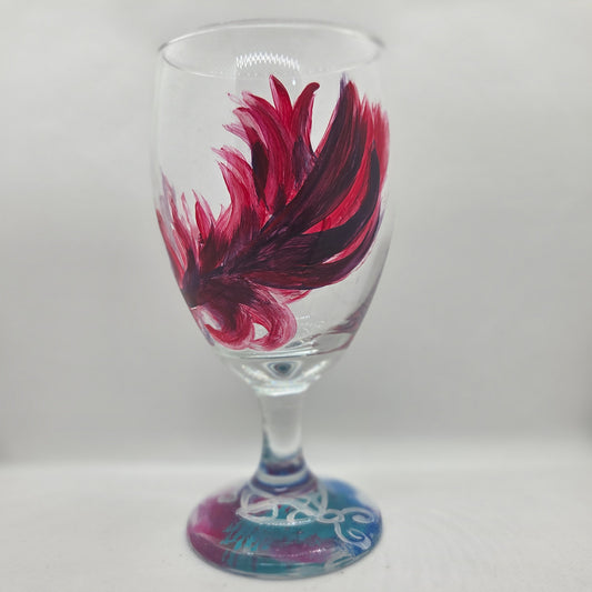 Hand-painted 16 oz goblet with a floating cardinal feather in bold red with black and subtle purple shadows