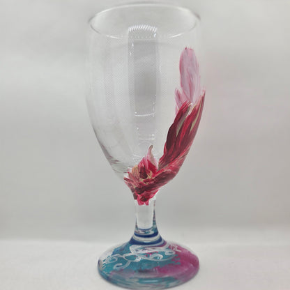 Hand-painted 16 oz glass with a graceful cardinal feather in brilliant red, orange, and golden yellow