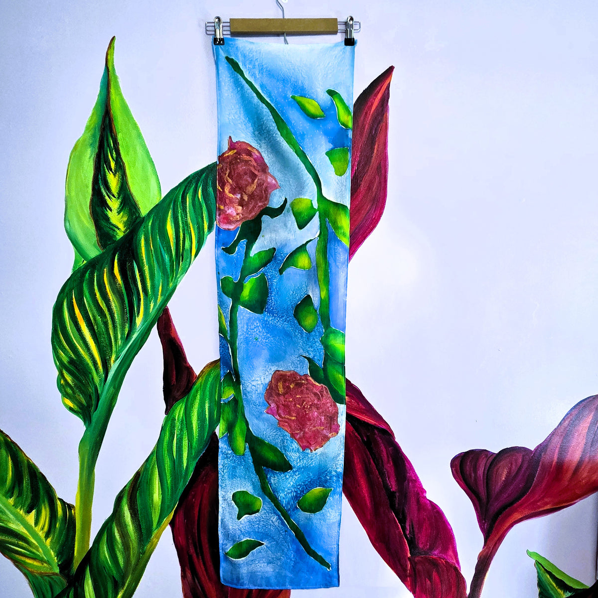 Rosewater Sky hand-painted habotai silk scarf with two mirrored roses on a textured blue background