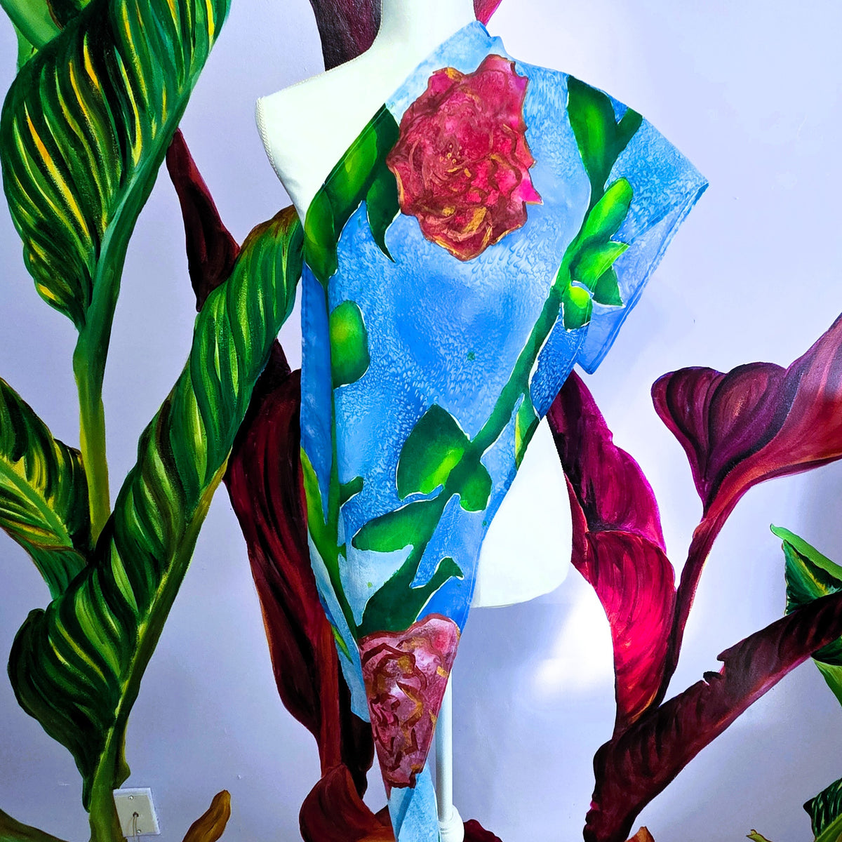 Rosewater Sky hand-painted habotai silk scarf with two mirrored roses on a textured blue background