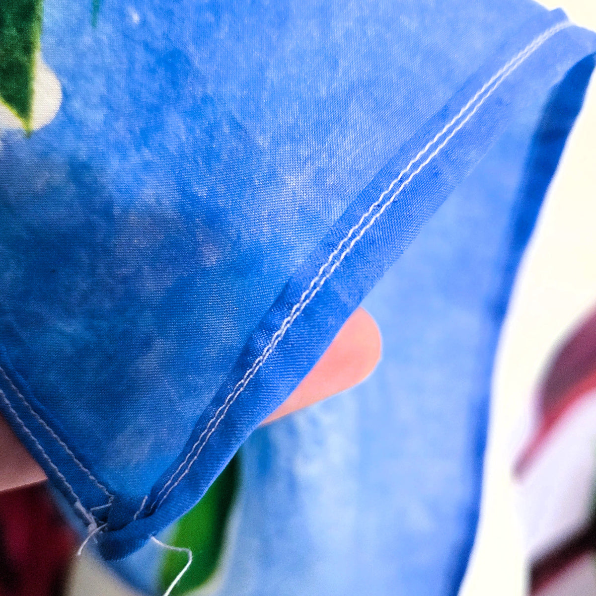 Detail of Rosewater Sky silk scarf showing hand rolled hem and secure stitching